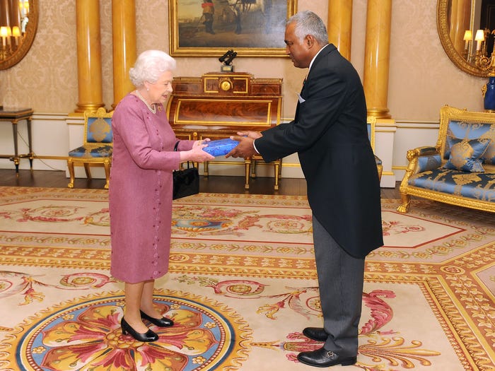 queen elizabeth ii receiving a gift